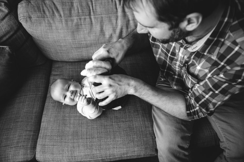 Edmonton Dad plays tickles with 6 month old baby during 6 month photo session. Fiddle Leaf Photography.
