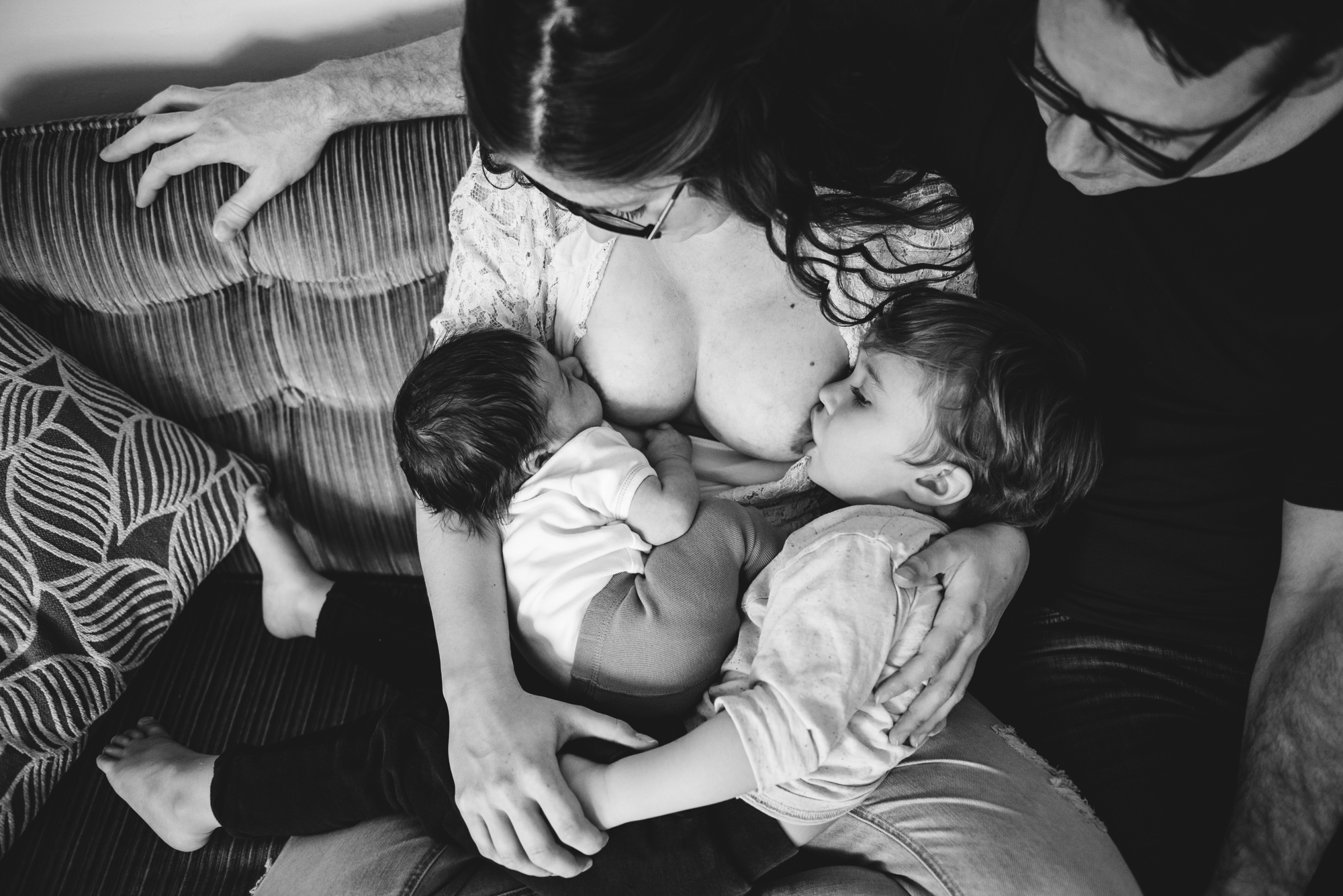 A mother tandem breastfeeds her toddler and baby in Edmonton, Alberta