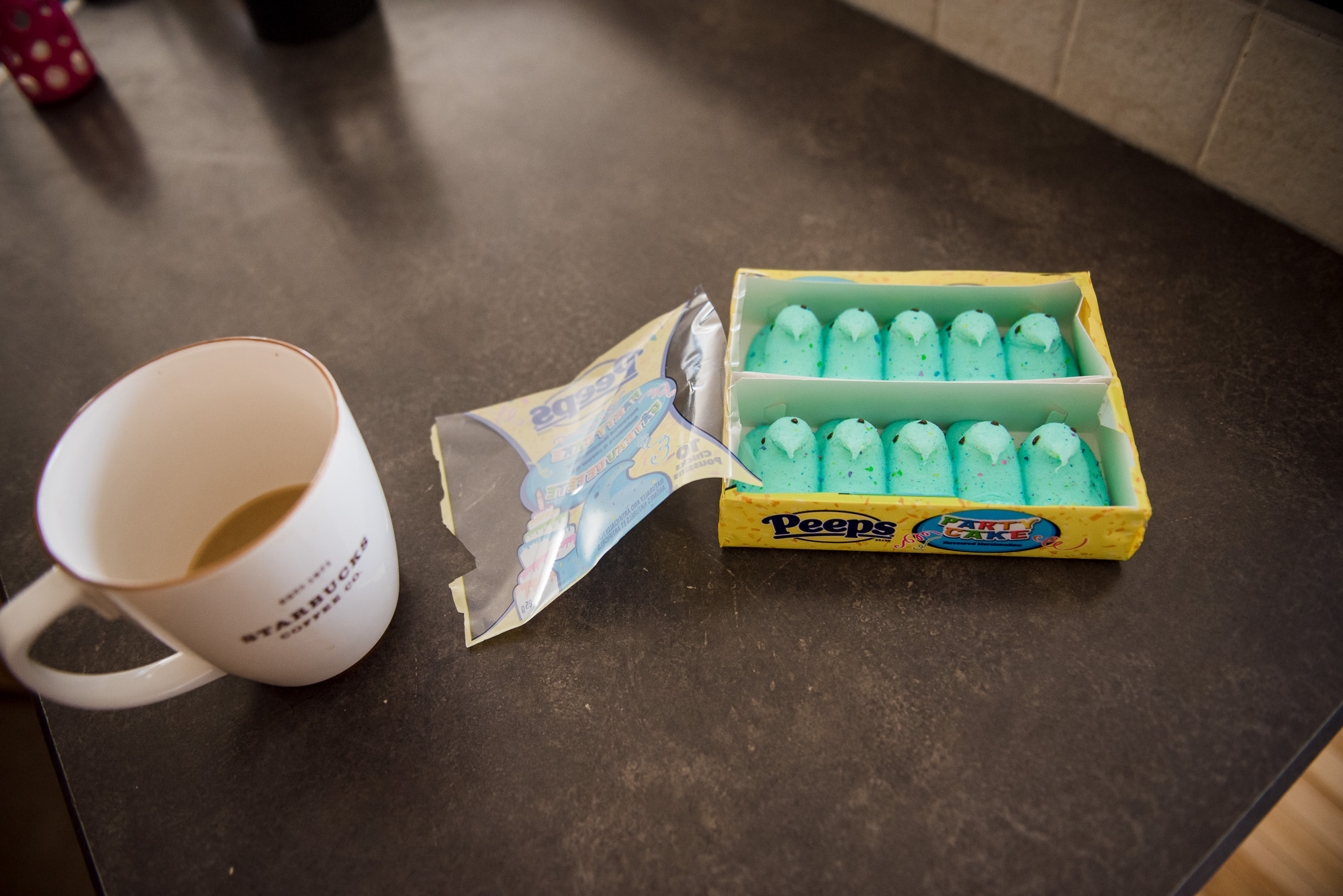A photograph of green marshmallow Peeps and coffee
