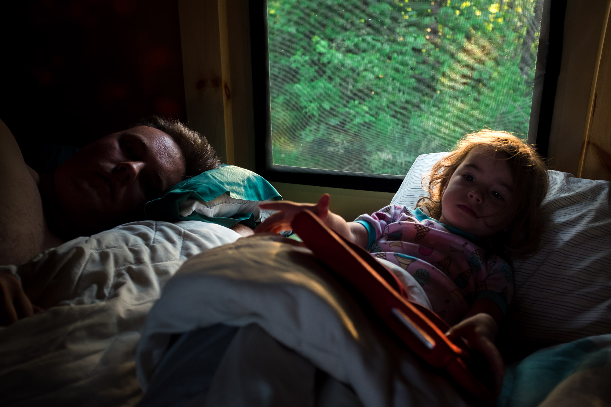 A dad and daughter sleep in an Otentik at Elk Island National Park