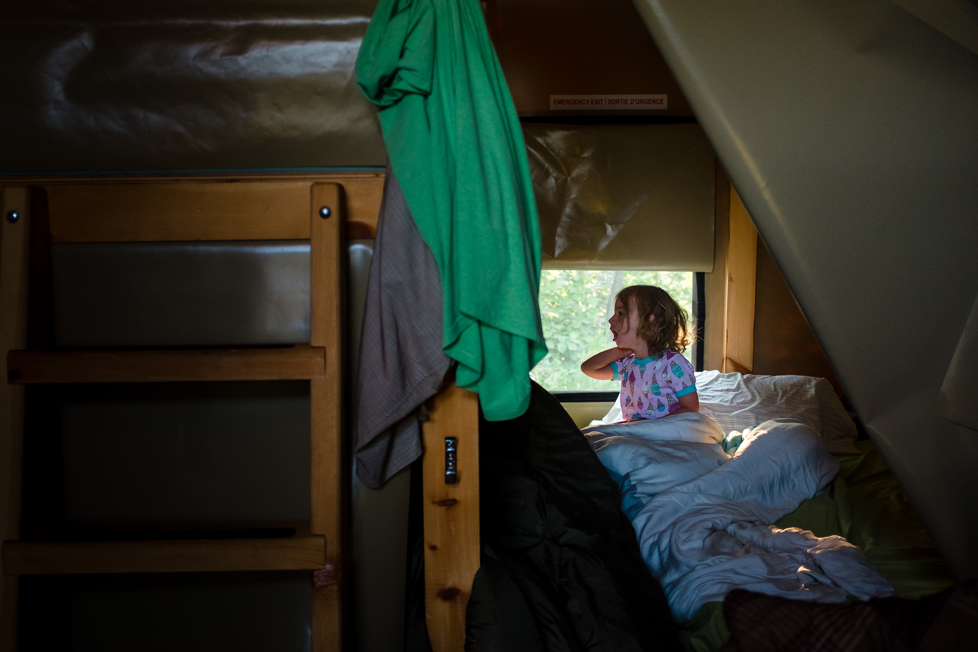 A young girl wakes up camping at Elk Island National Park 