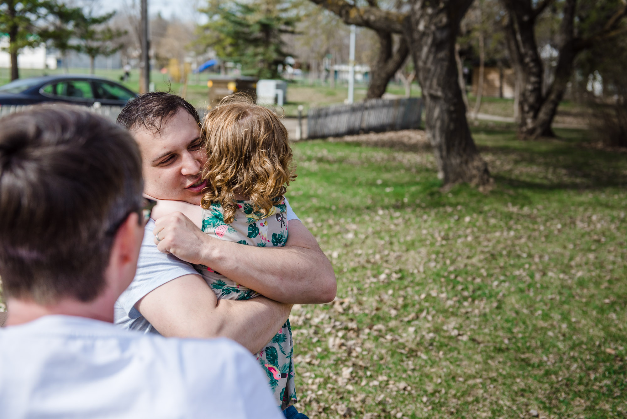 a dad hugs his little girl during a family photo session