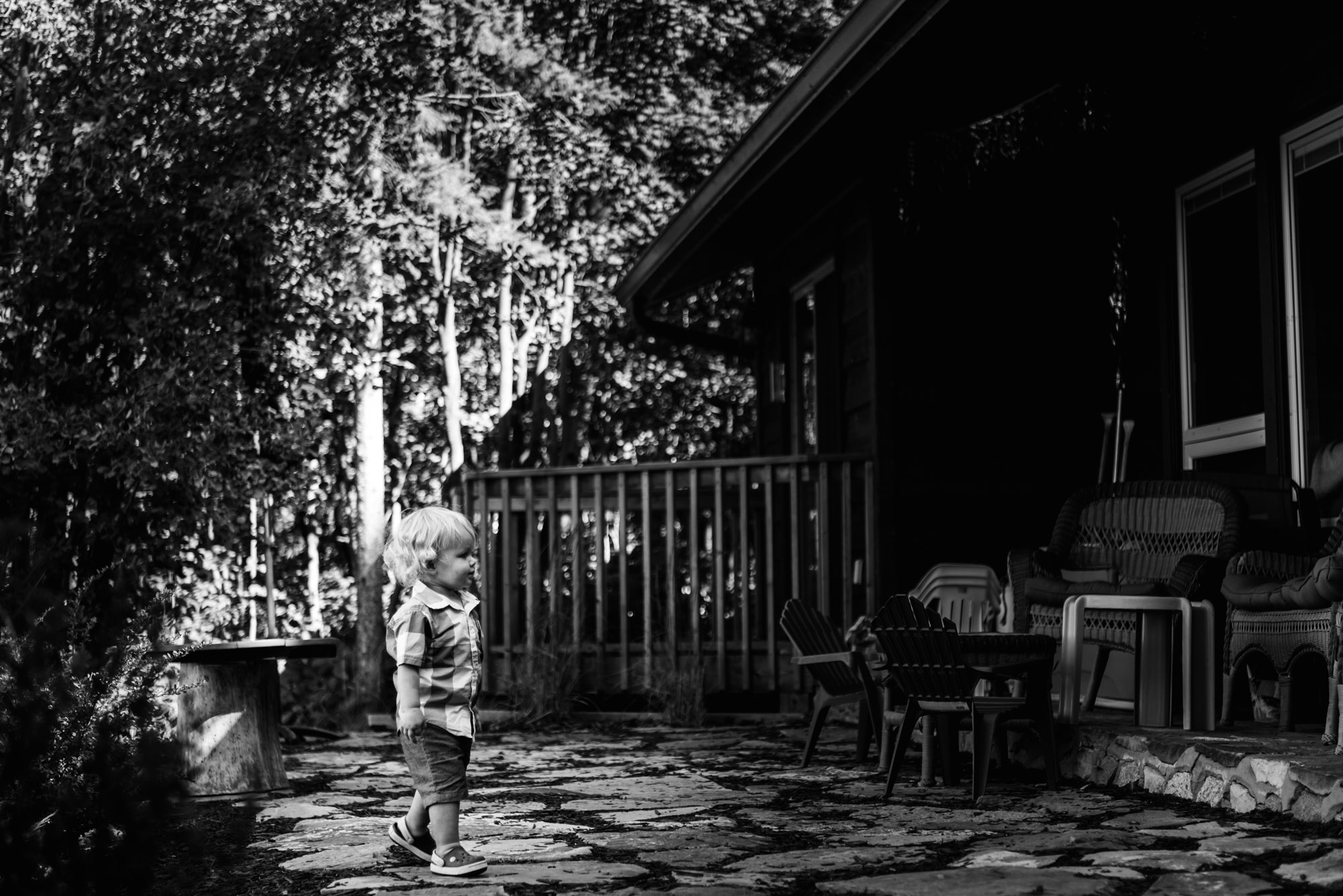 A little boy walks into his Pigeon Lake cabin during a photo shoot for a family gathering