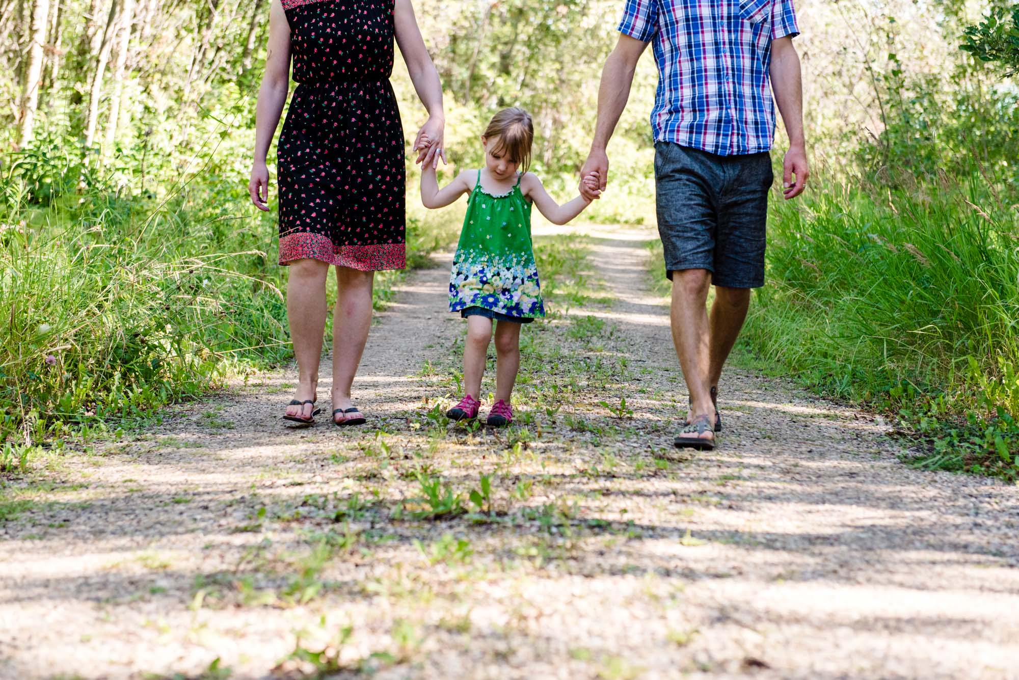 A family walks together down a lane at Pigeon Lake alberta