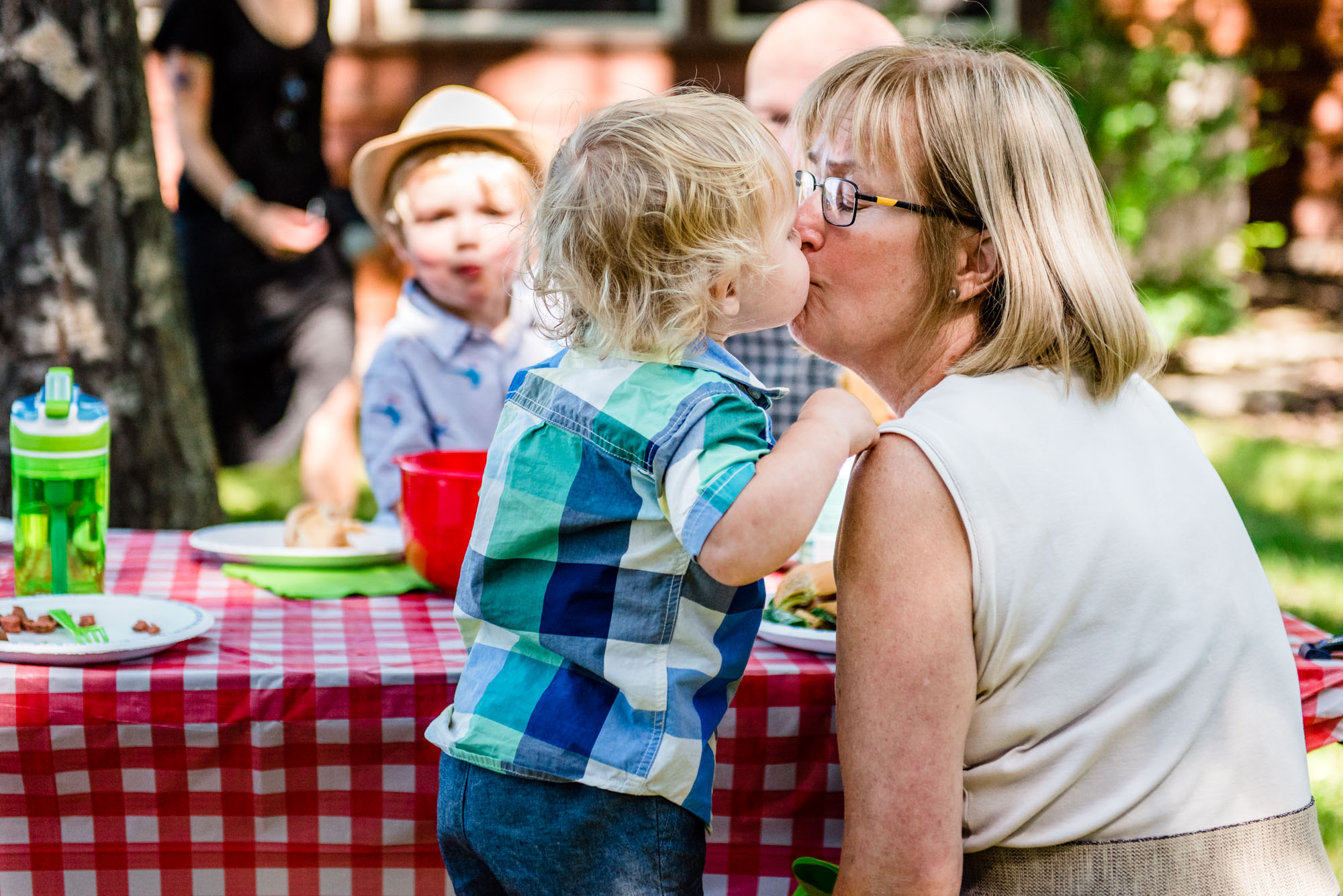 A little boy kisses his Grandma during a family reunion and photo shoot