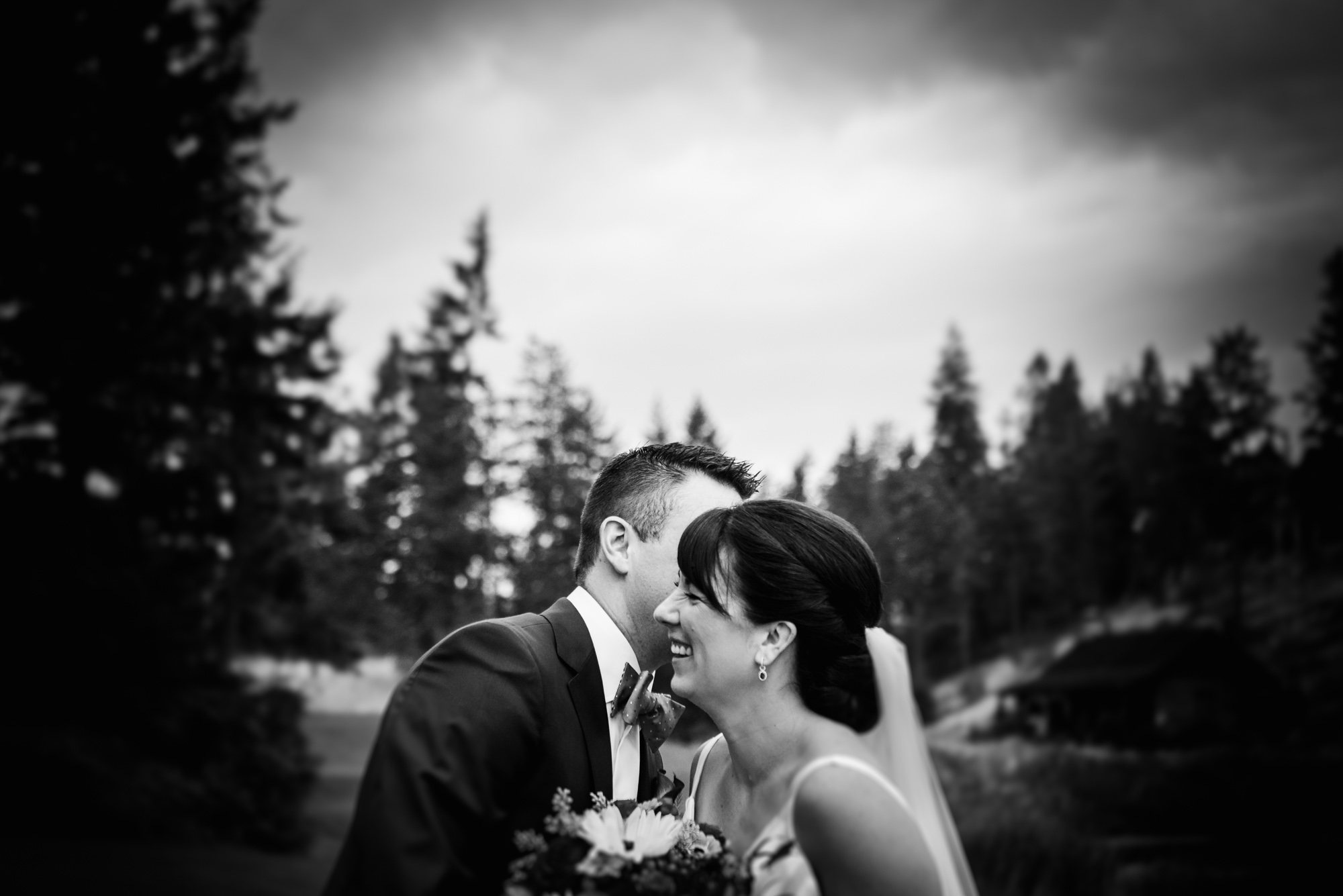 A groom whispers to a bride during a quiet moment at their Predator Ridge Resort wedding 