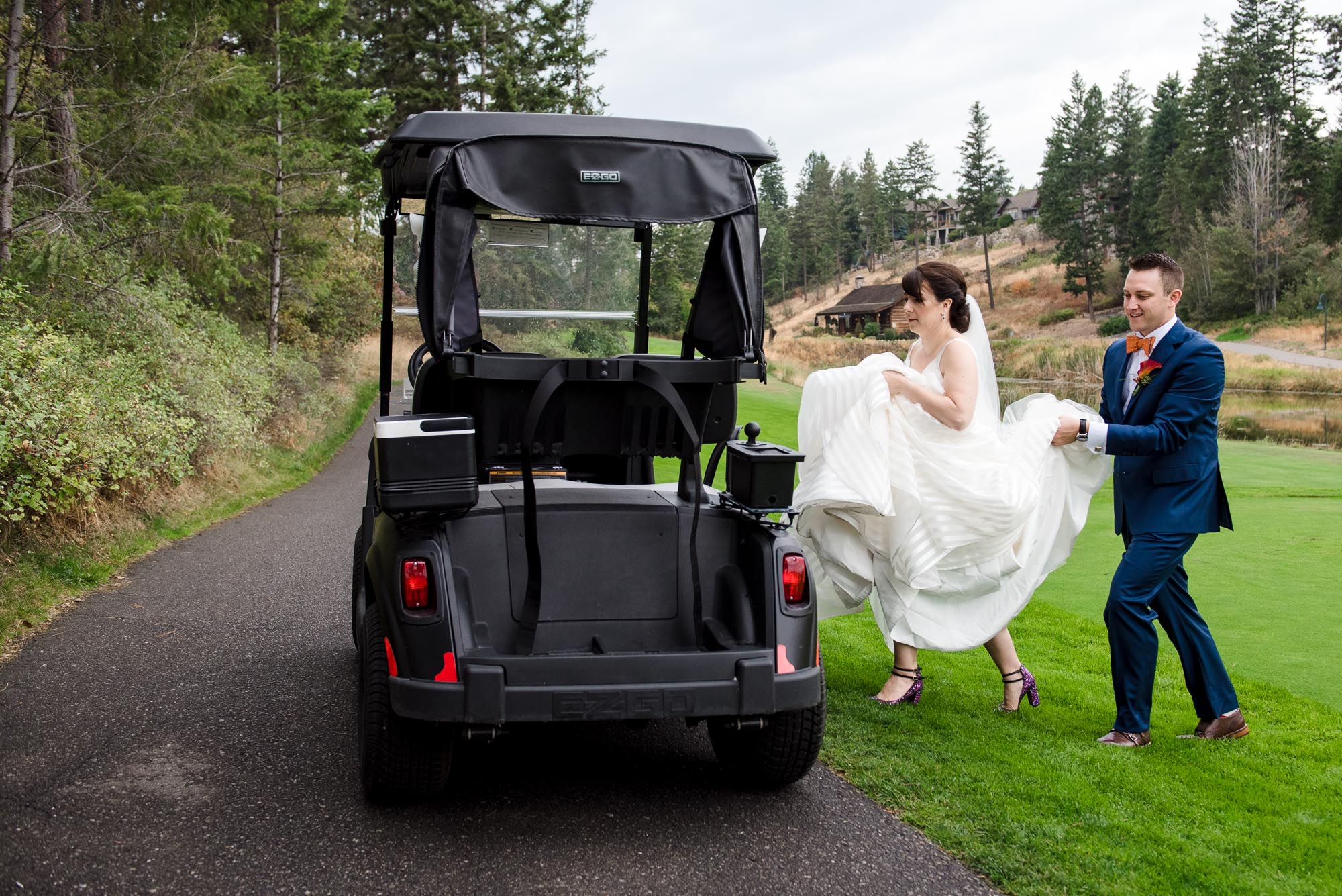 A bride gets into a golf cart during her wedding at Predator Ridge Resort in Penticton
