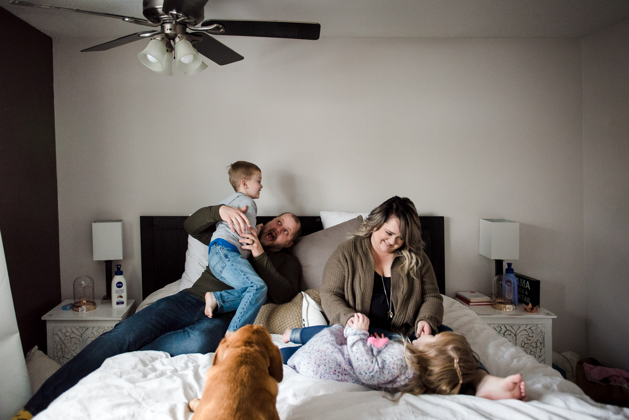 Fiddle Leaf Photography, one of the best family photographers in sherwood park captures natural joy as a family wrestles