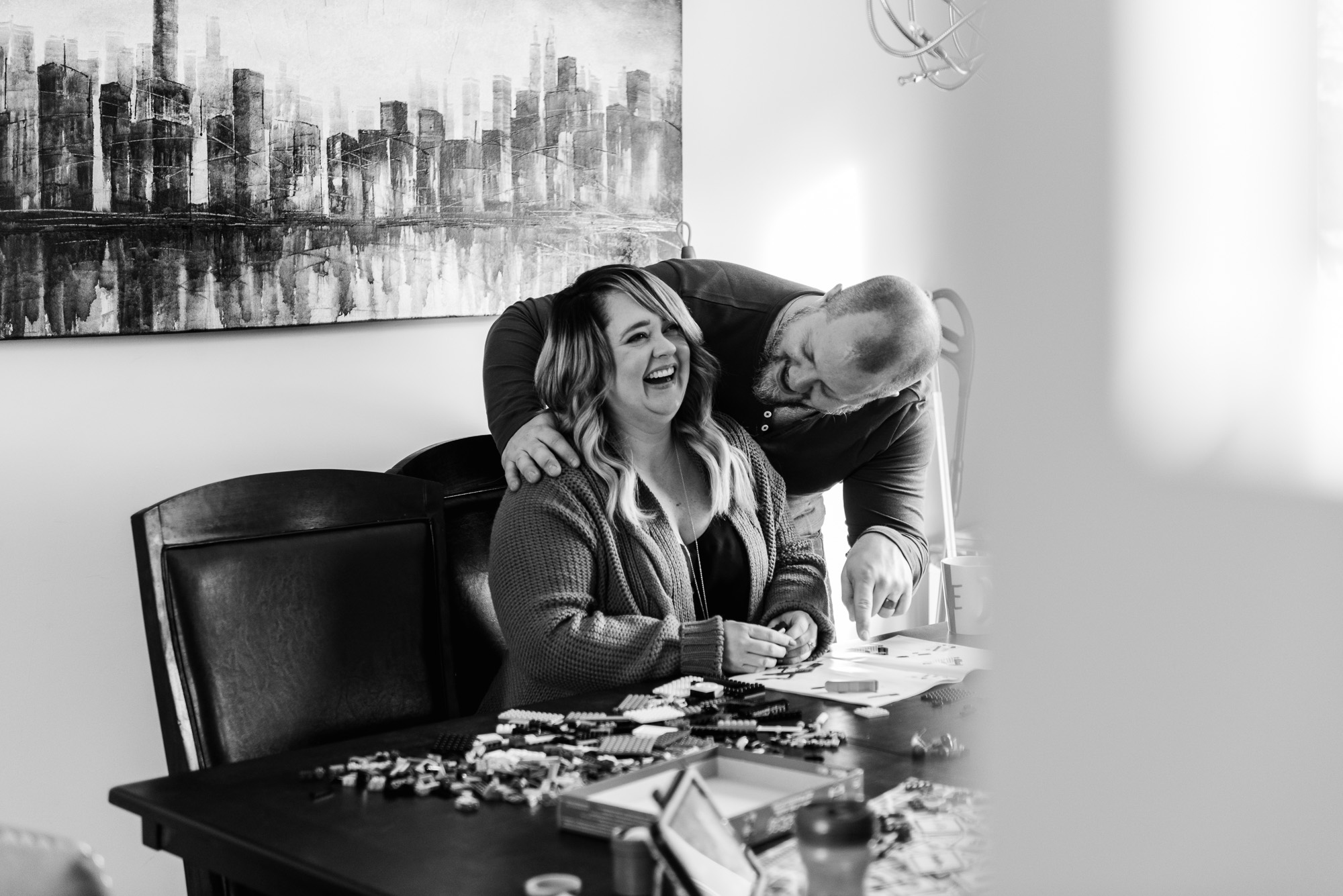 A husband laughs with a wife in their Sherwood Park home