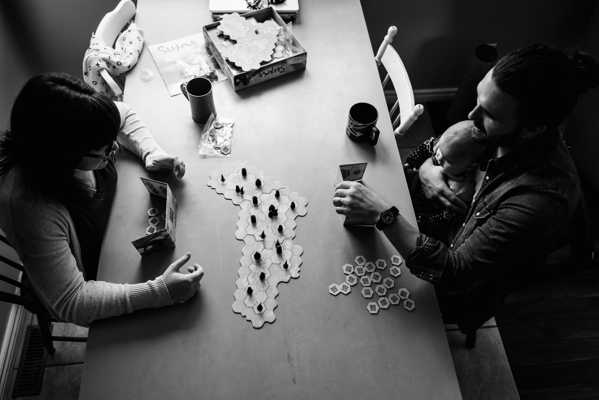 A family plays a game at their kitchen table in their fort saskatchewan home. 