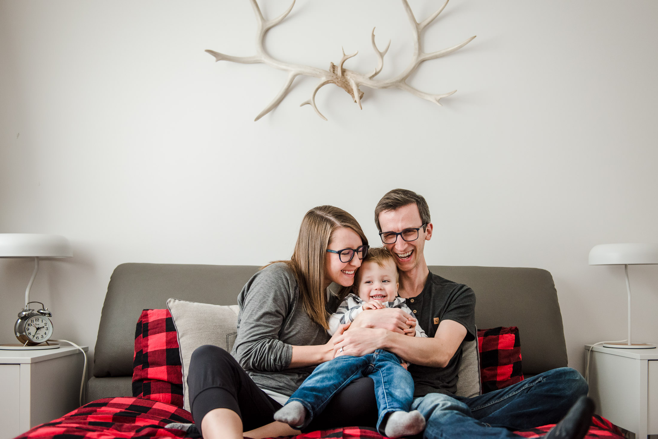 A family snuggles while taking family photos in an Edmonton home