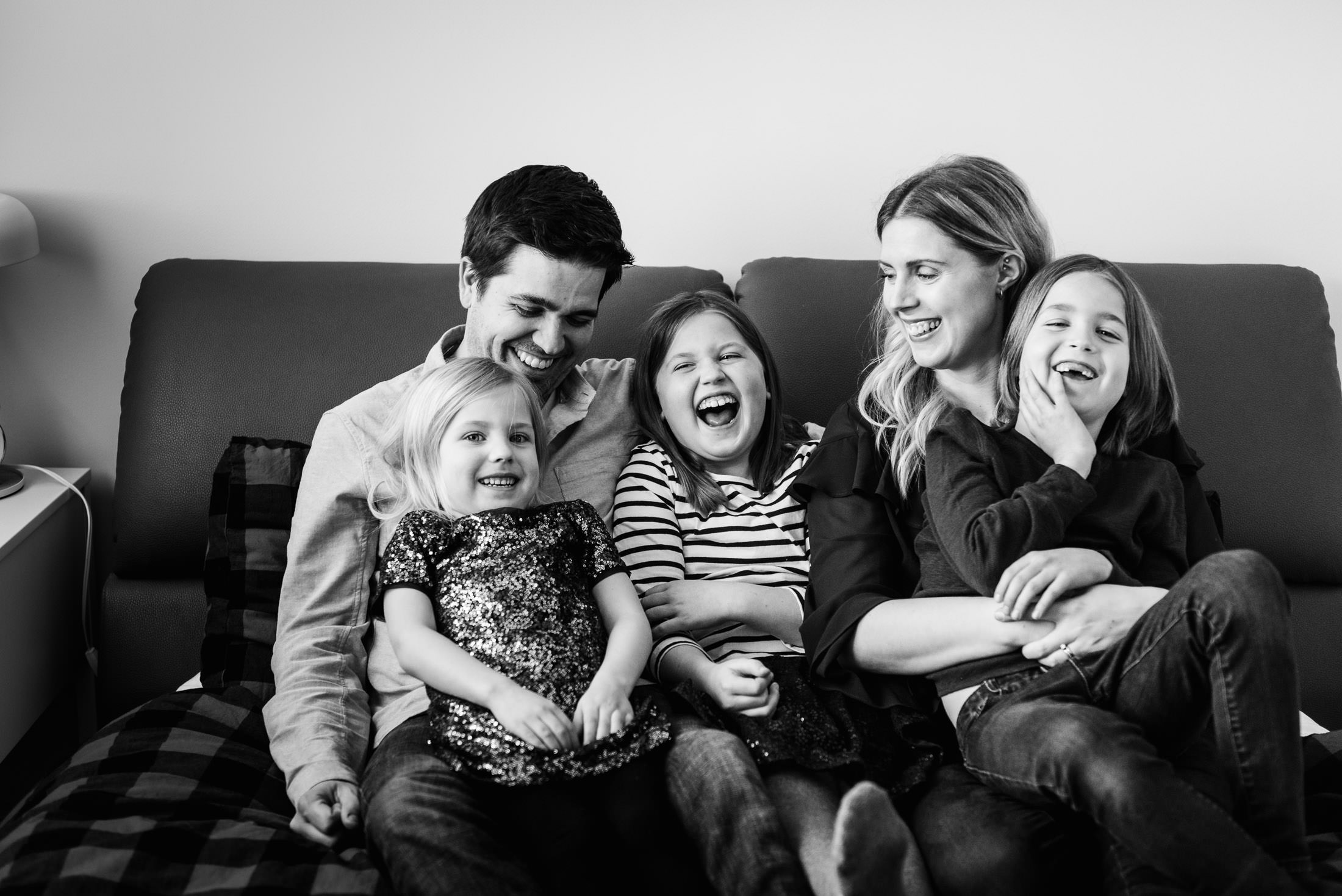 A family giggles together during family photos