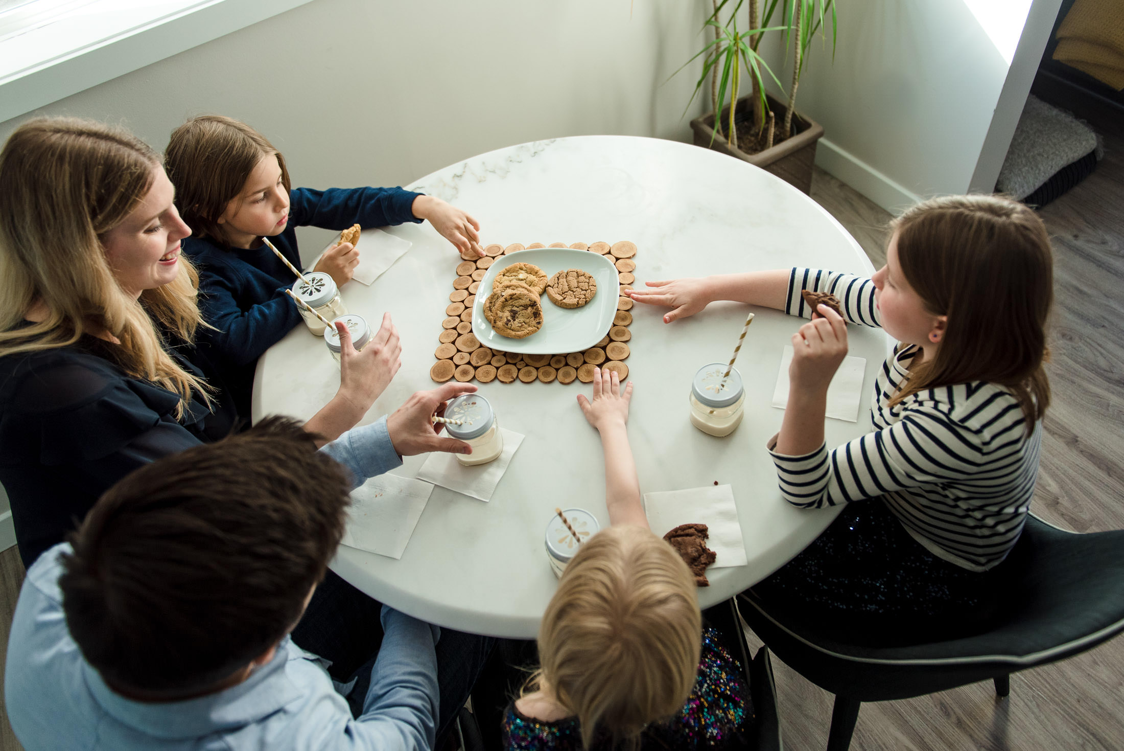 A family eats cookies during a christmas mini session in Edmonton