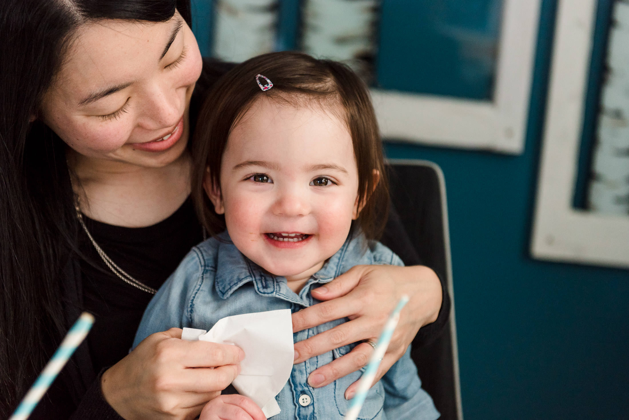 A litlte girl smiles with her mom