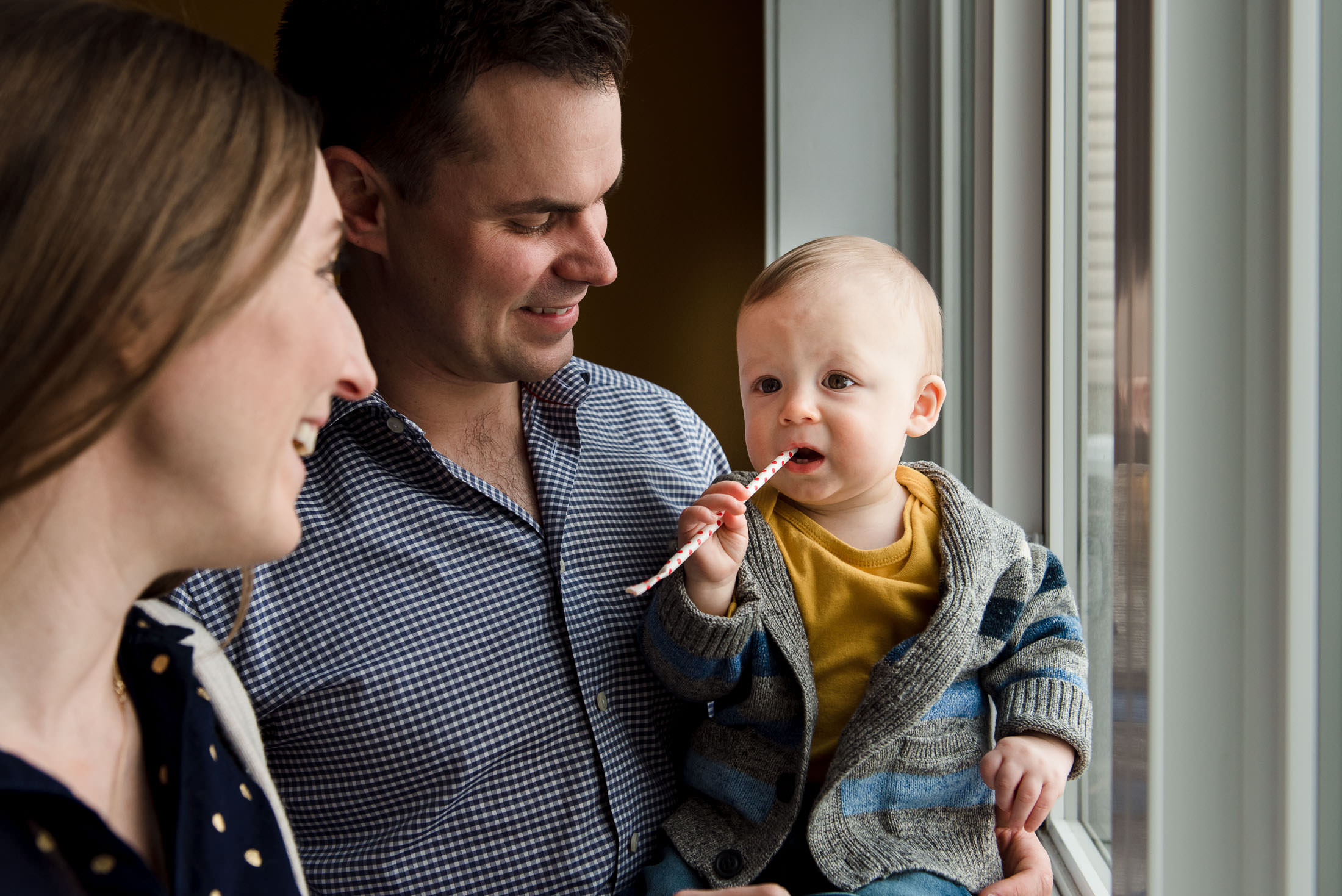 A little boy and his parents have family photos taken