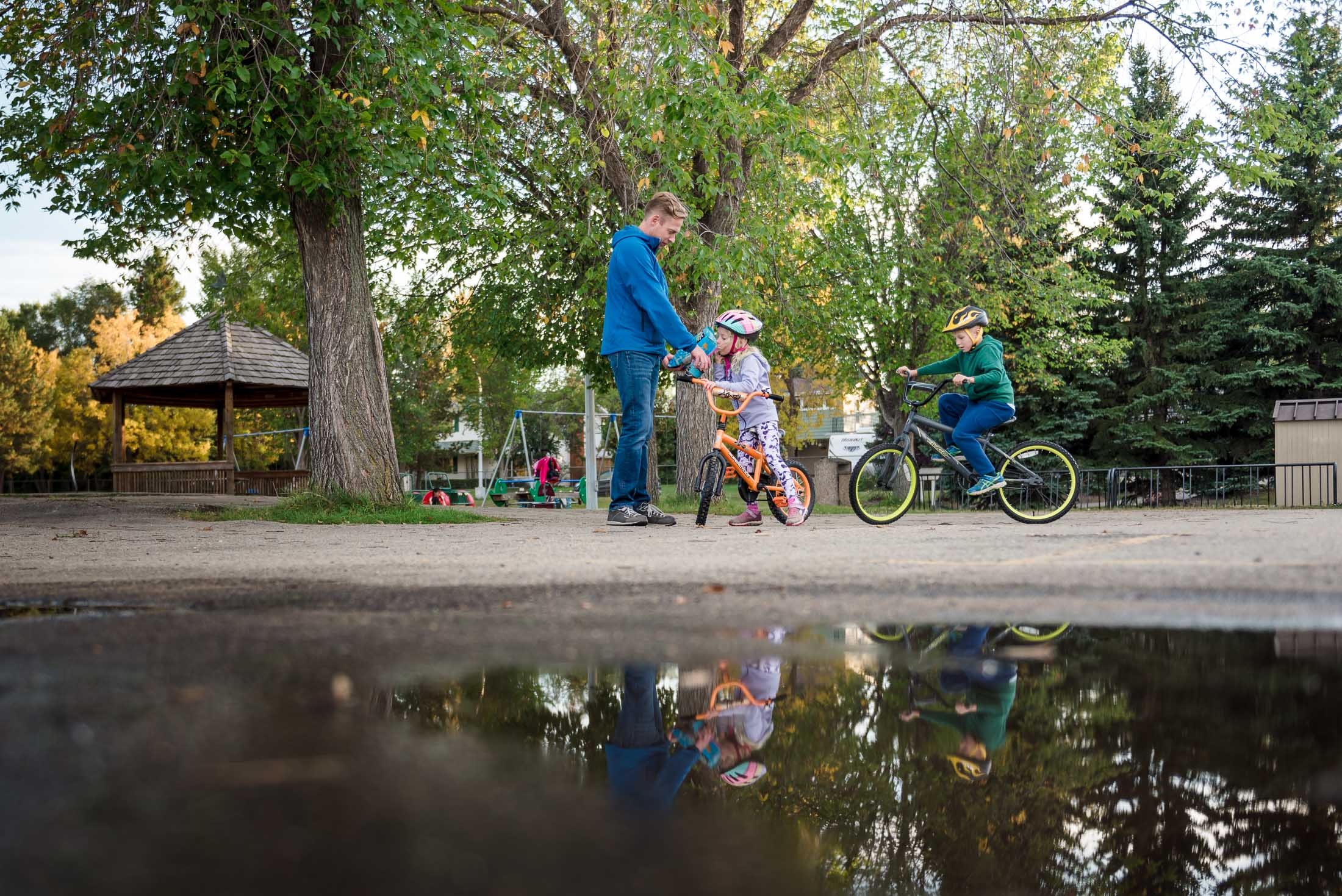 A family rides bikes during a family photo session