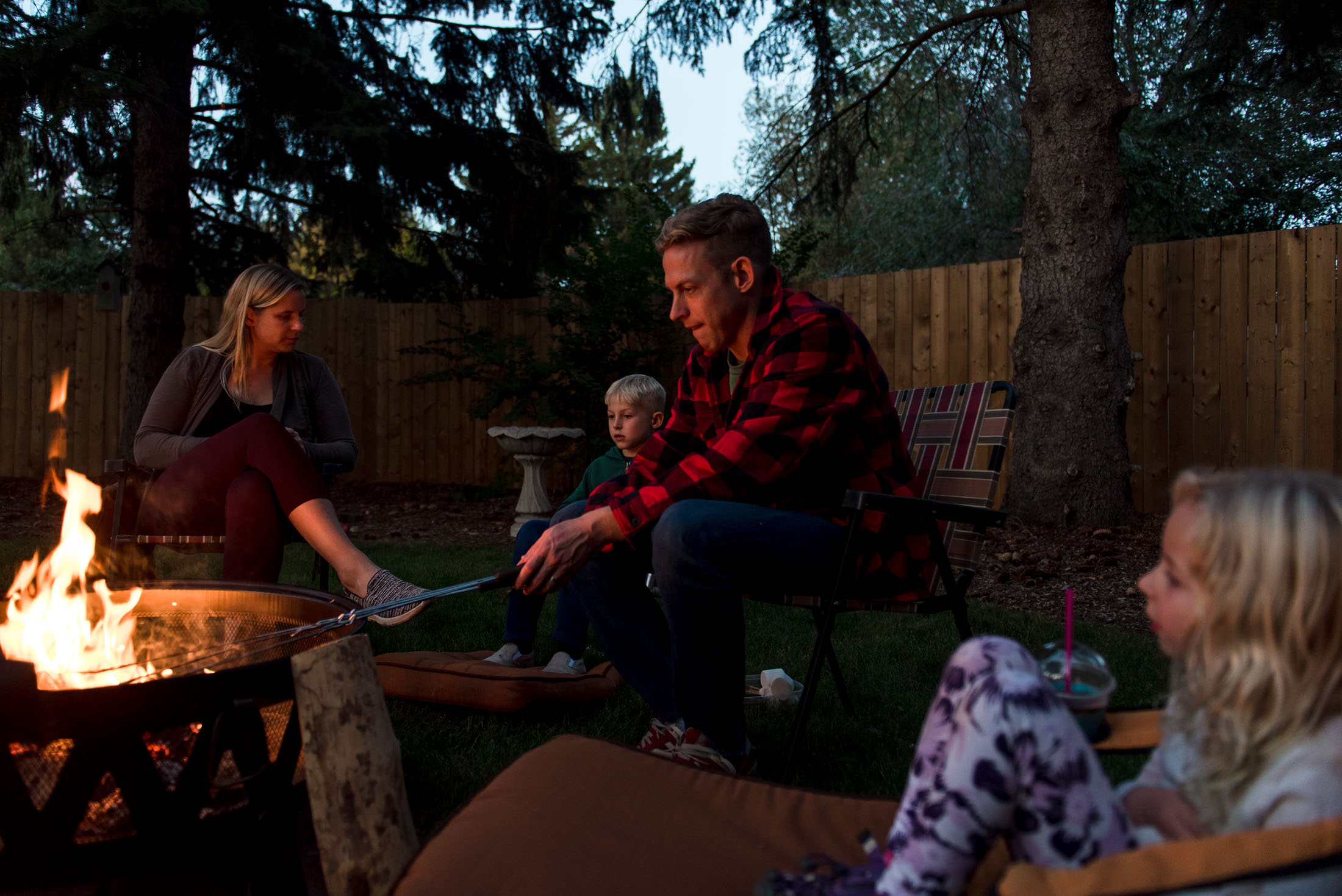 A family roasts marshmallows as part of their Edmonton family photo session