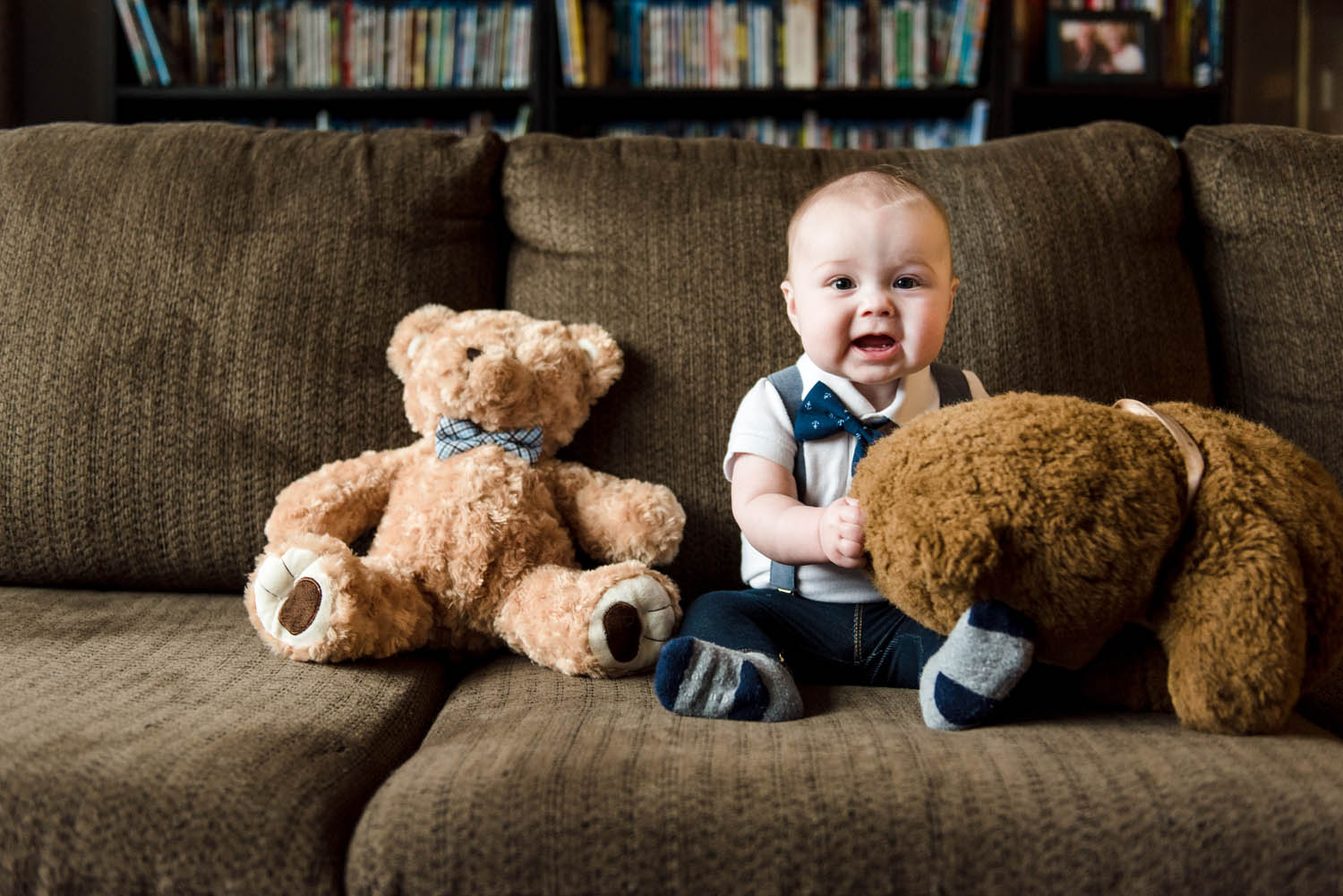 A 6 month old baby photos session in a Sherwood Park home with a smiling baby boy surrounded by heirloom teddy bears.