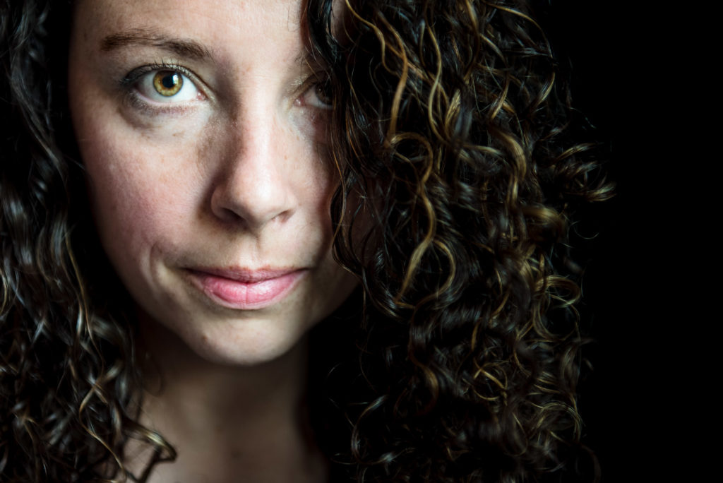 A self portrait of a woman with curly hair