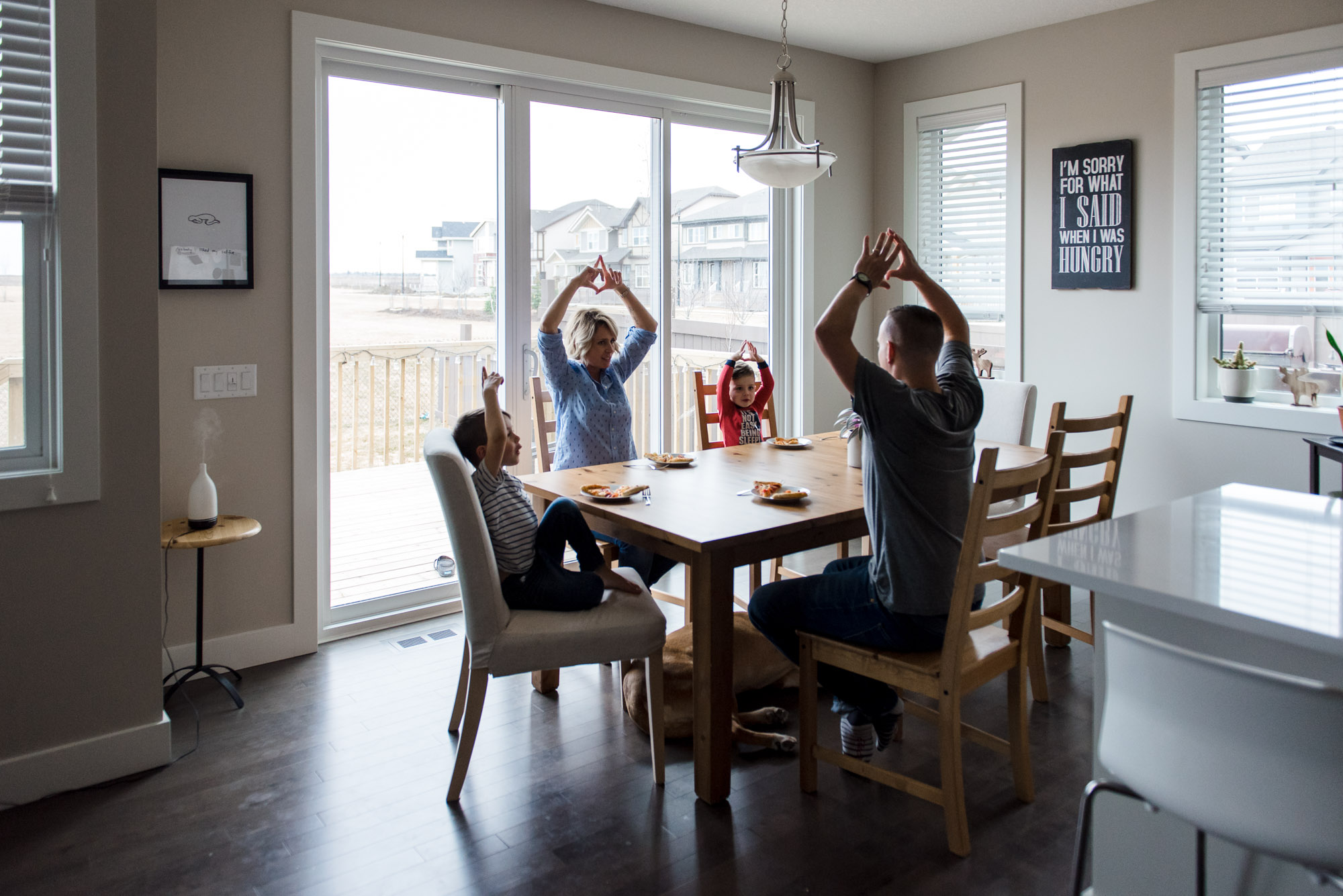 A family sits in their Edmonton home for dinner during a lifestyle photo session