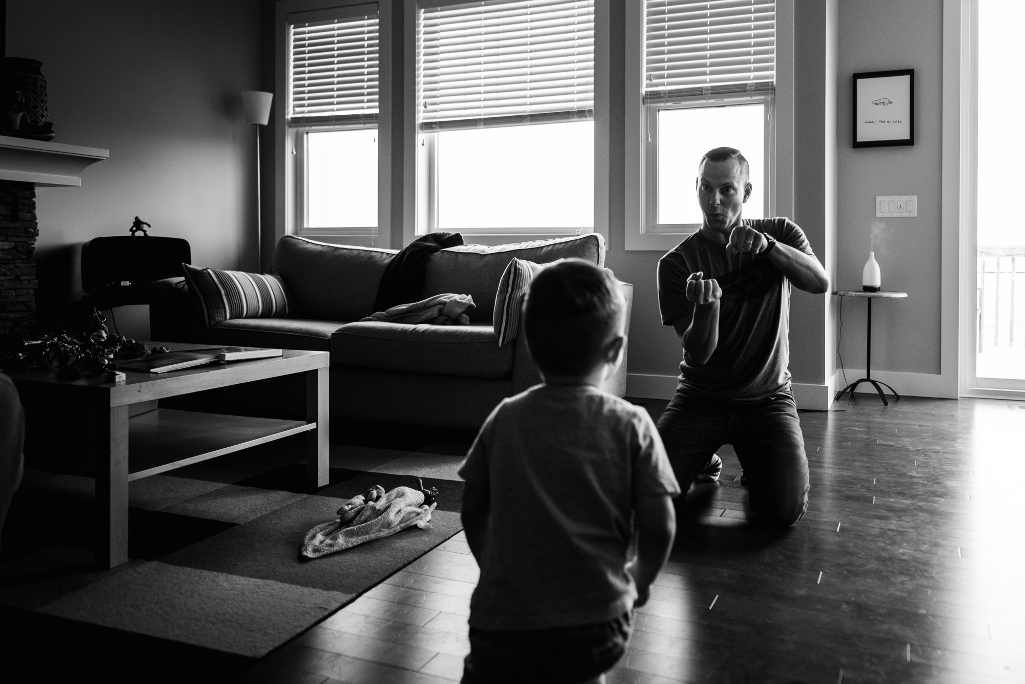 A dad plays with his son during a photo session with Fiddle Leaf Photography