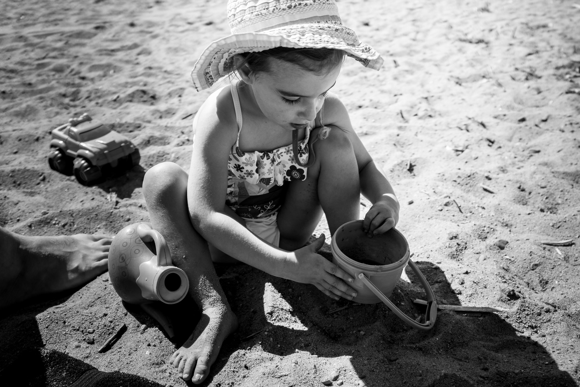 A little girl plays in the sand at Elk Island National Park