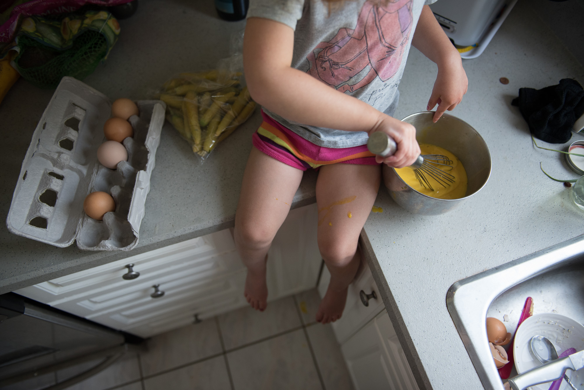 A straight out of camera overhead shot of a girl  mixing eggs