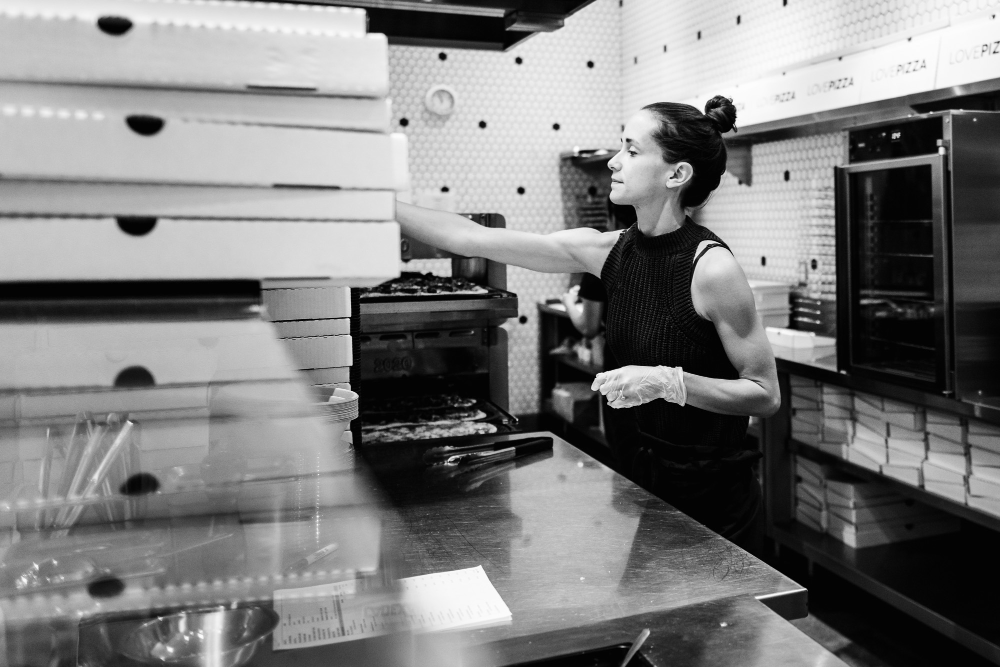 Love Pizza's owner Braede Harris works on the line making pizza