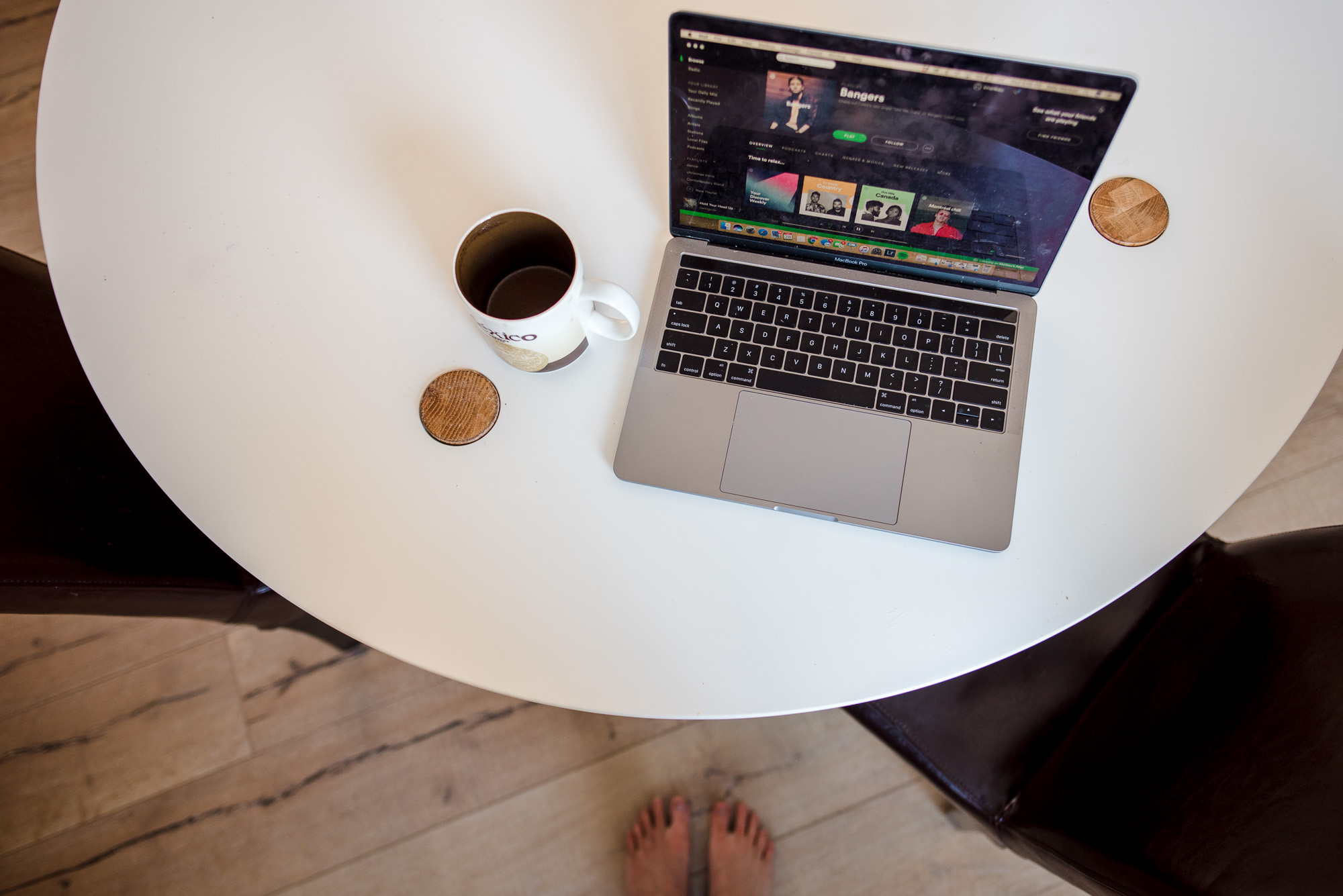 a laptop and coffee cup on a table 