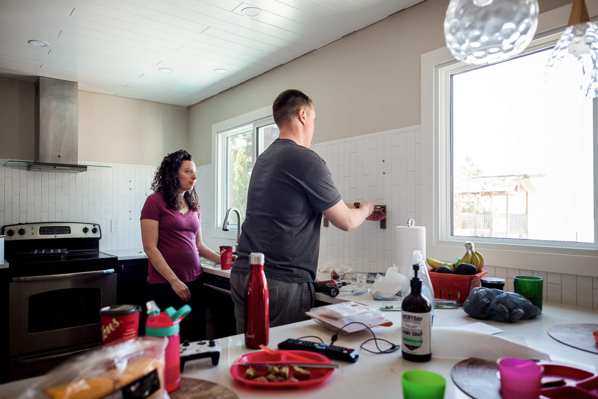A woman and her husband work on their kitchen in their Sherwood Park home. 