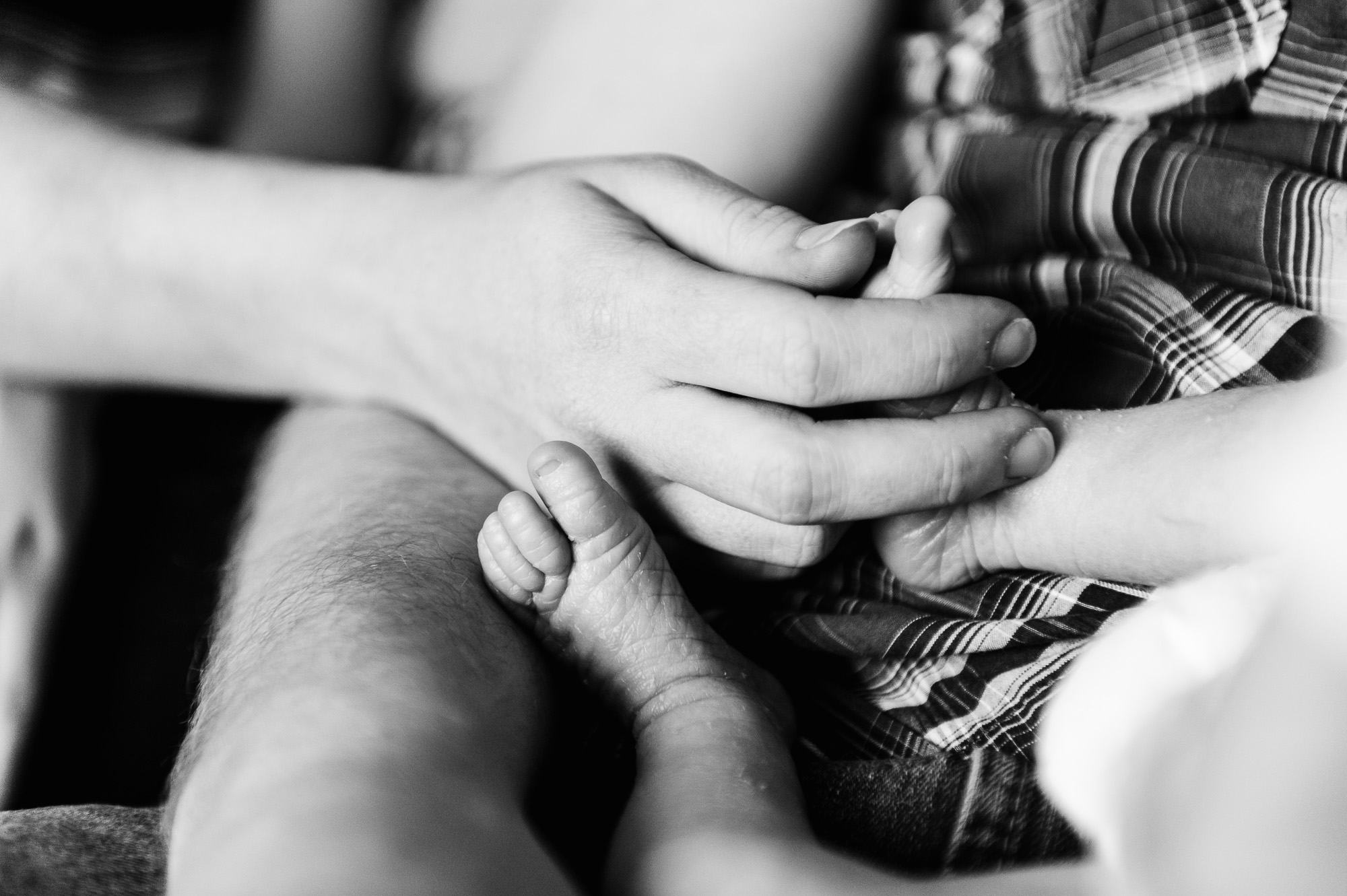 A mom tickles her baby's feet