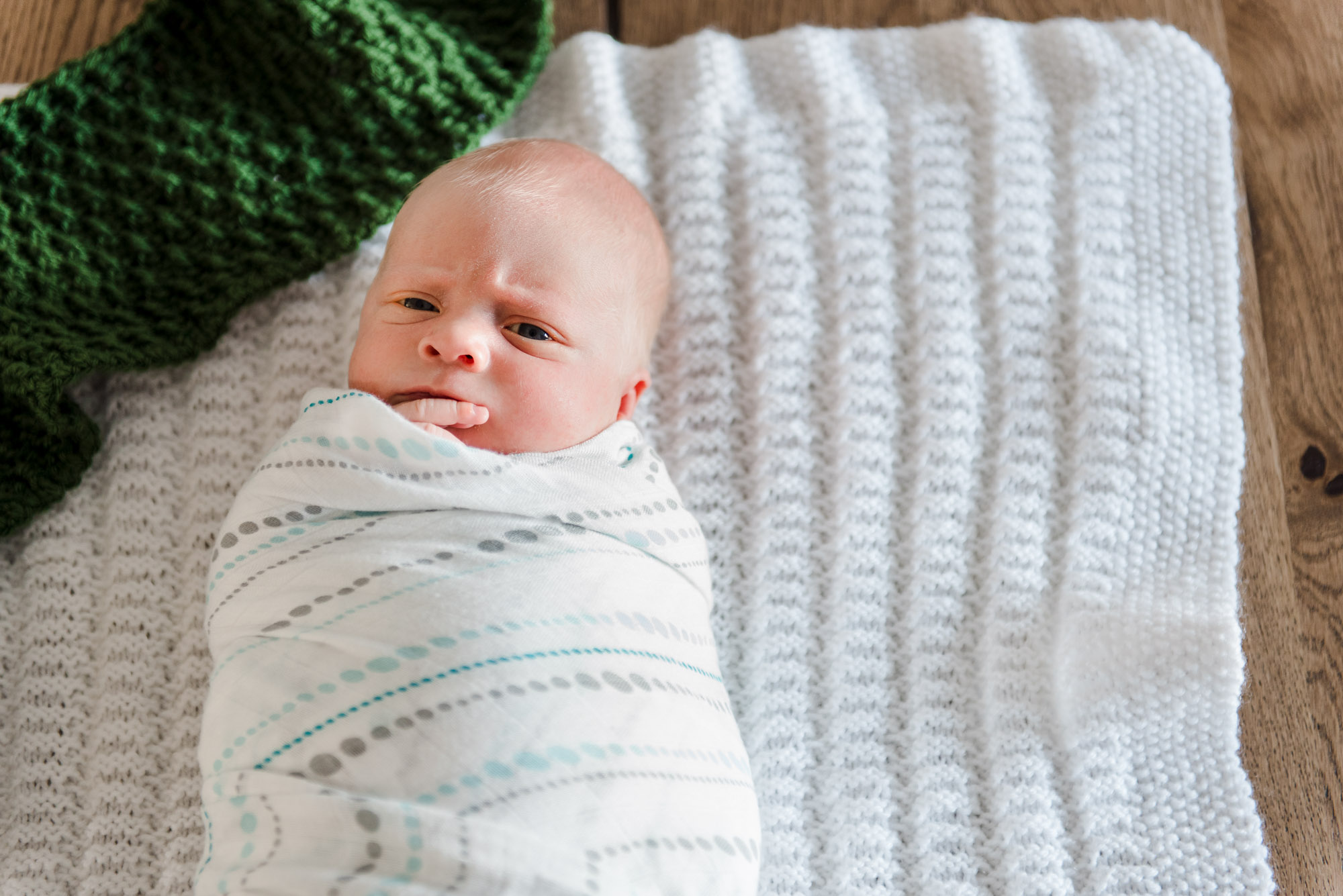 A portrait of a newborn baby on a vintage blanket