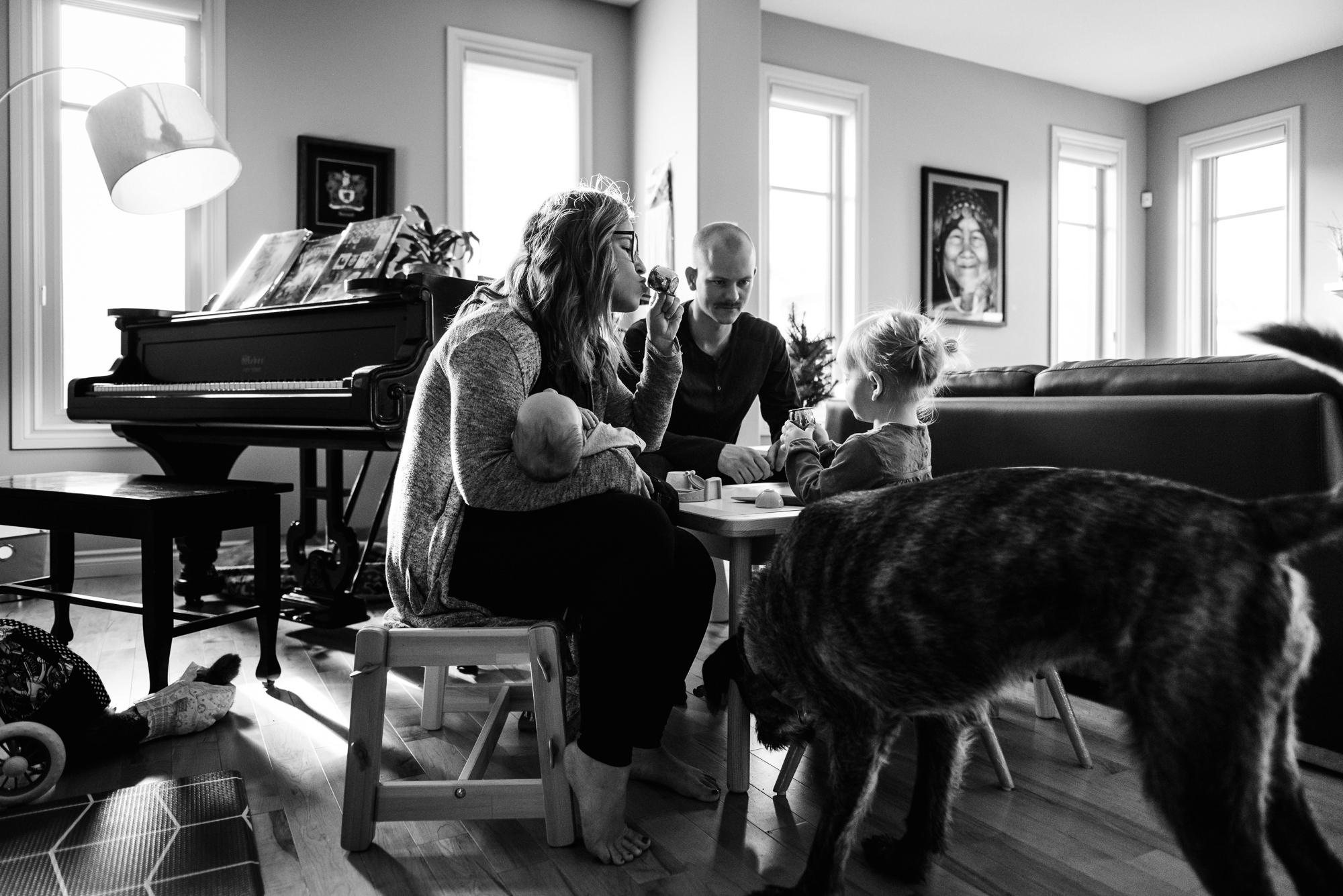 A family has a little tea party during a family photo session