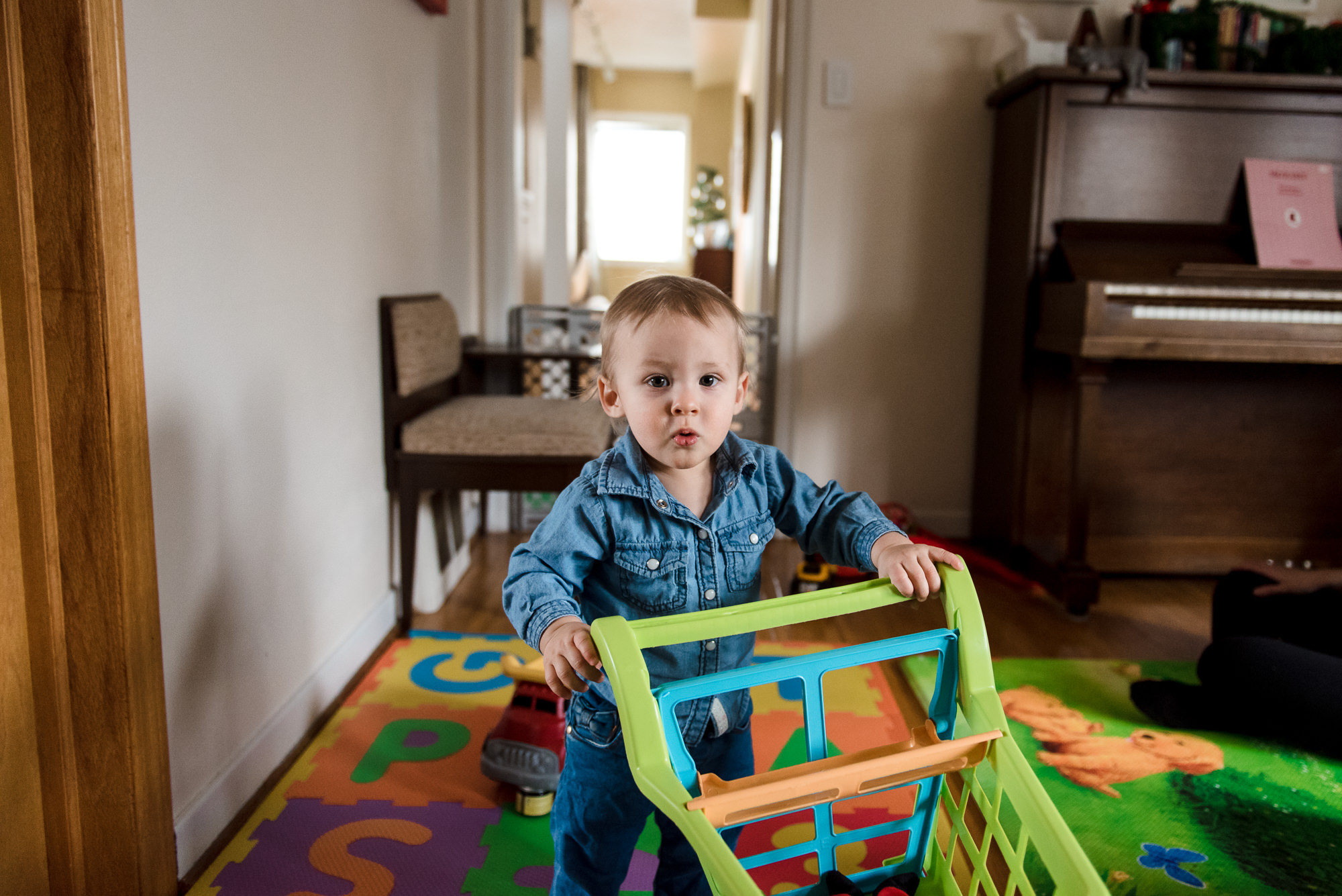 a little boy plays with toys during a family photo session in his Edmonton home. 