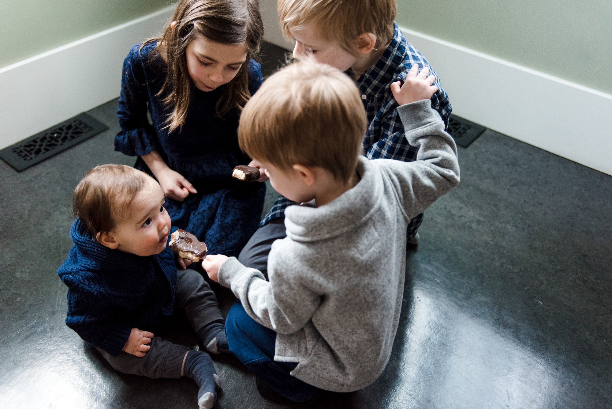 Siblings eat ice cream in their Edmonton home during an Edmonton Family Photography session