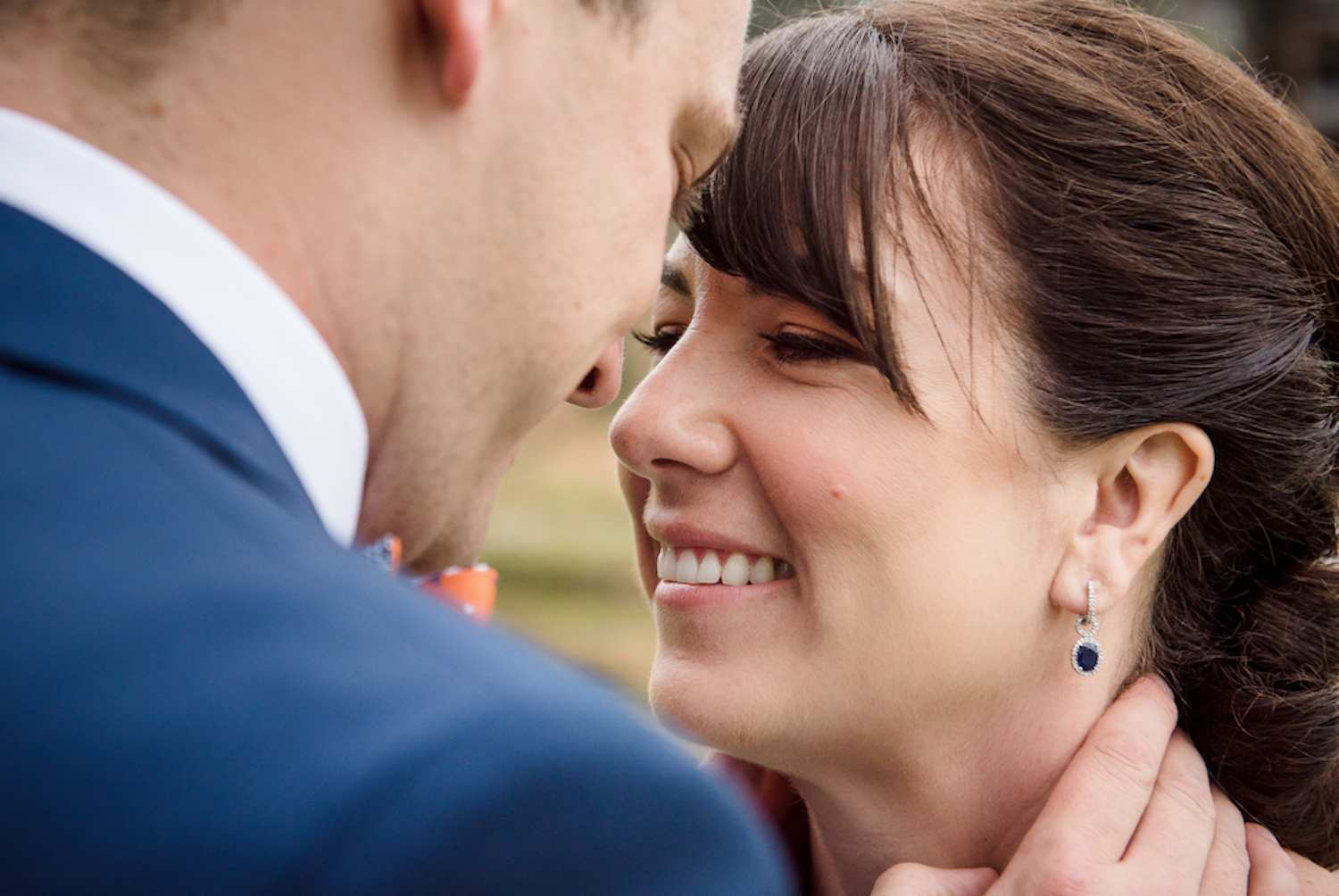 A man caresses his wife's face during an anniversary photo session in Edmonton