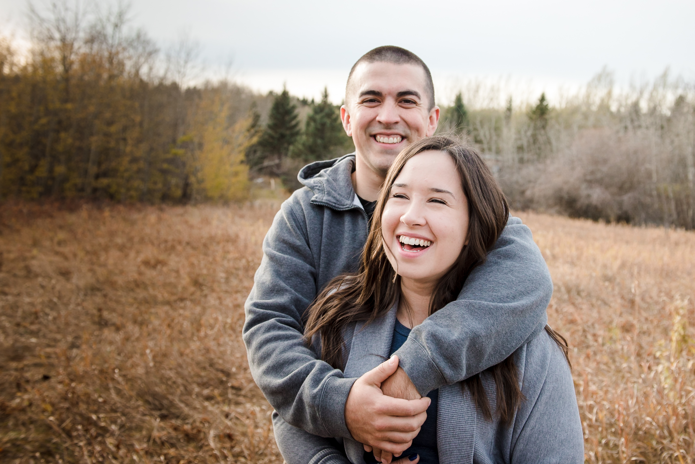 A couple laughs during a couples photo session in Sherwood Park