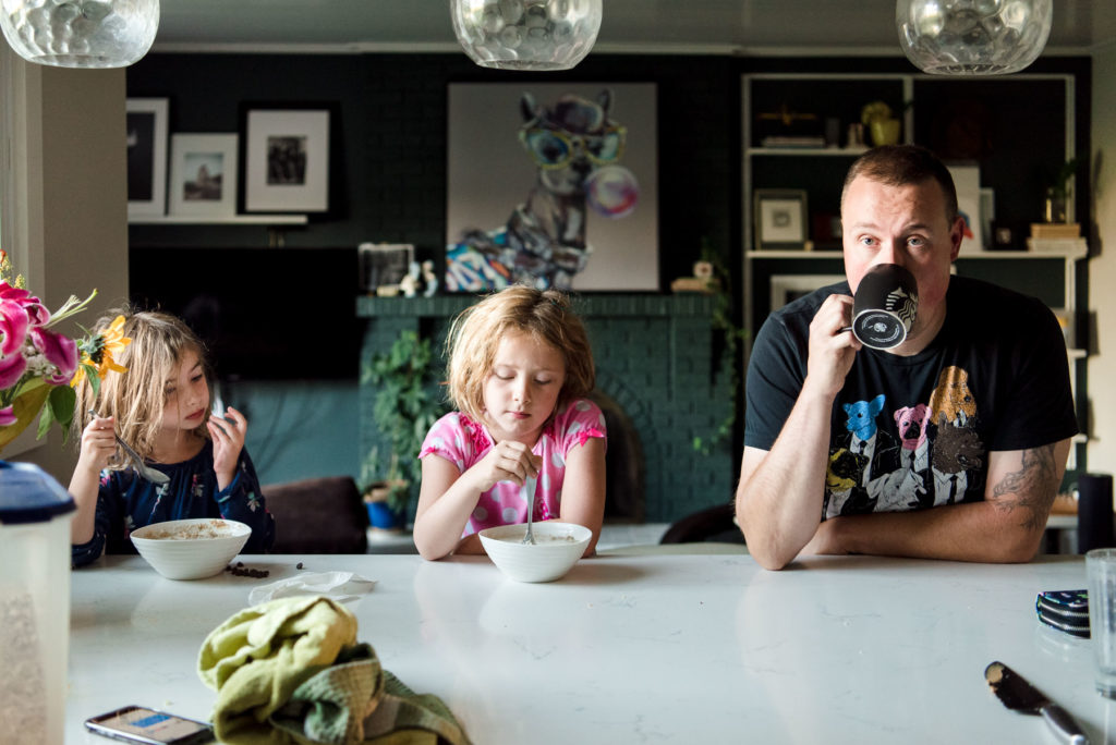 A family sits in their sherwood park home during breakfast