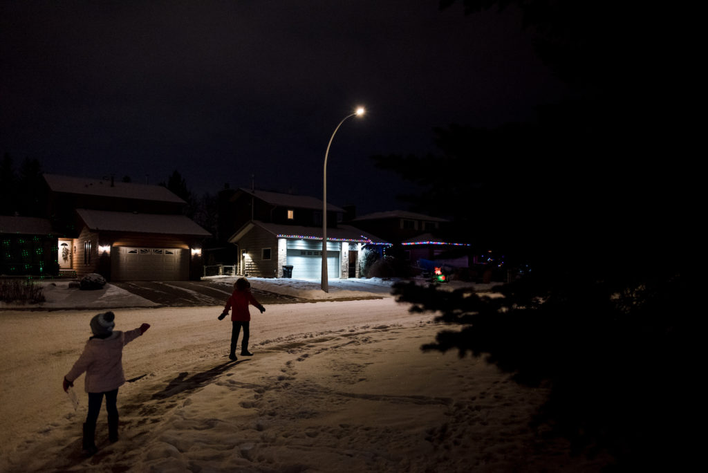 Kids look through their Edmonton neighbourhood during a Christmas light scavenger hunt. 