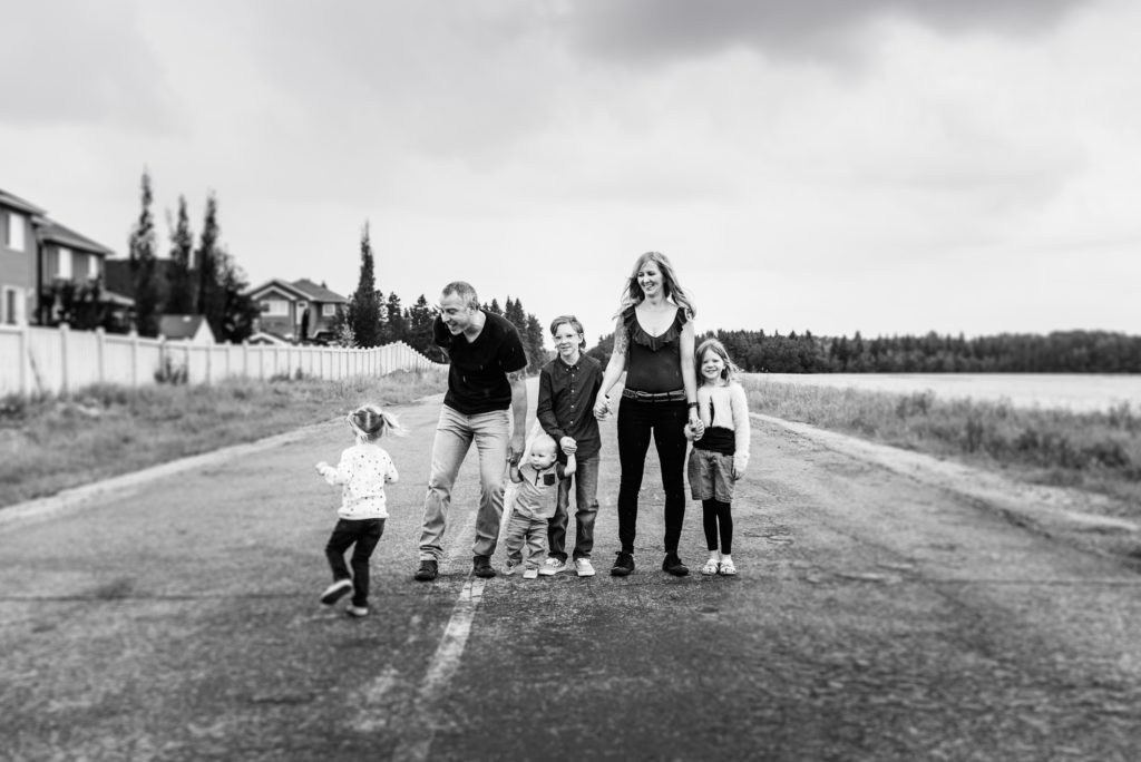 A family stands for casual portraits photo session in St. Albert