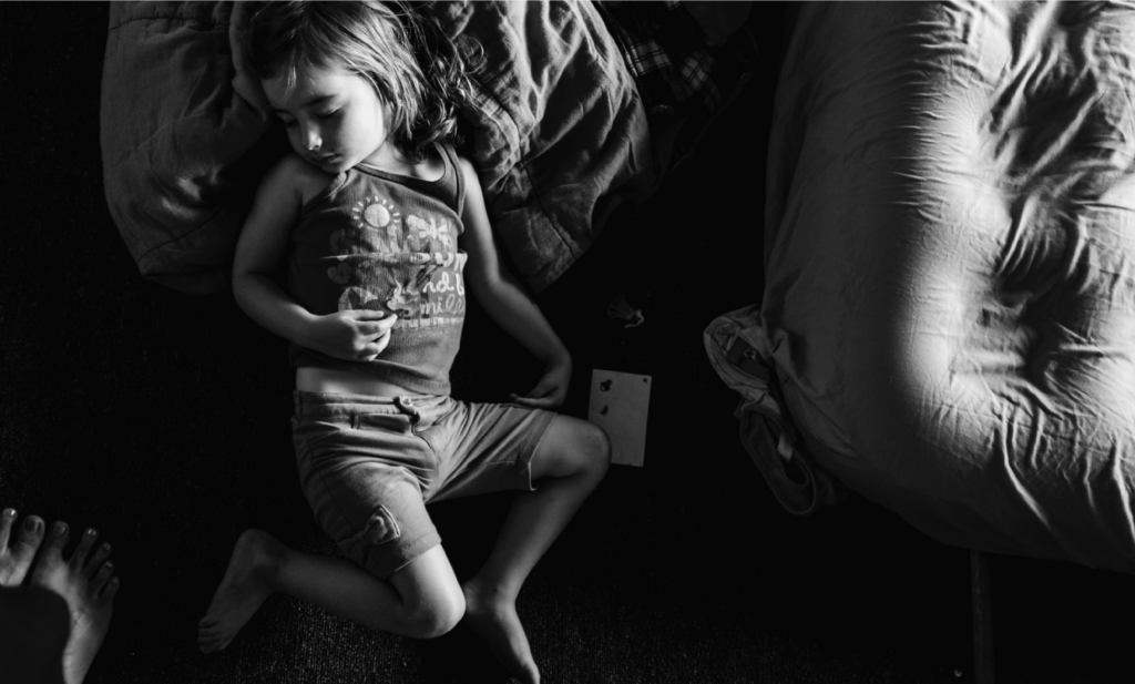 A little girl sleeps on an air mattress. Mom photo tips from Edmonton Photographer Kelly Marleau. 