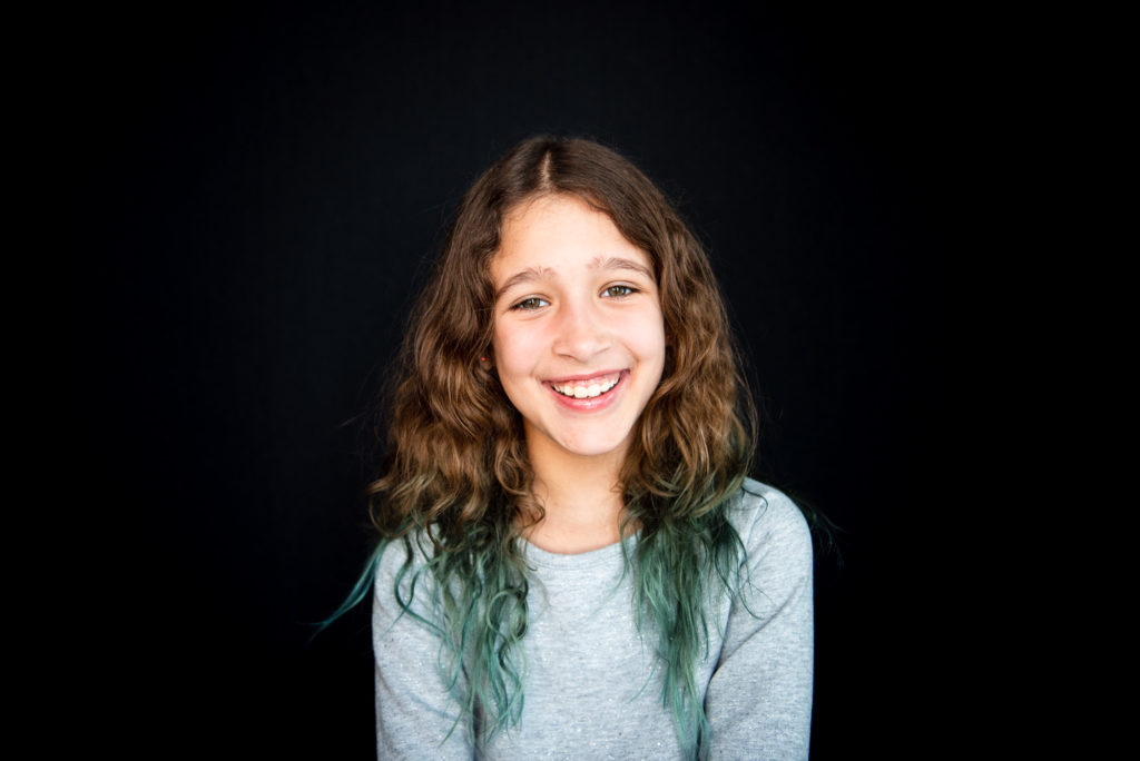 A girl sits for her school photo in Edmonton alberta. 