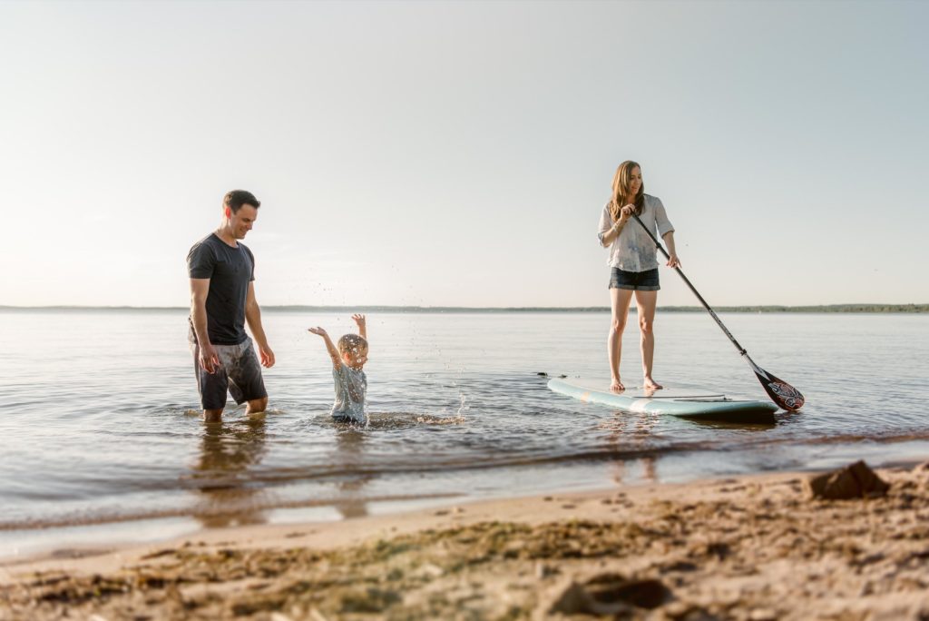 A family plays  and paddleboards on Pigeon Lake. Pigeon Lake photographer