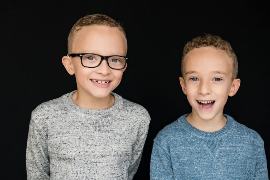 What to wear for school photos. Two brothers photographed in grey and light blue sweaters